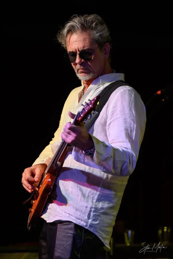 Bob Michaels playing guitar on stage