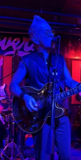 Rik Avalos singing and playing guitar