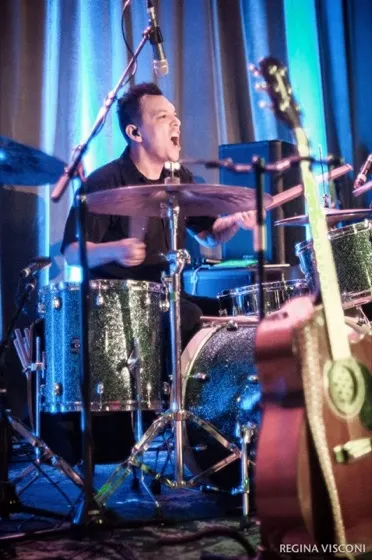 Sonny Sanchez singing while drumming